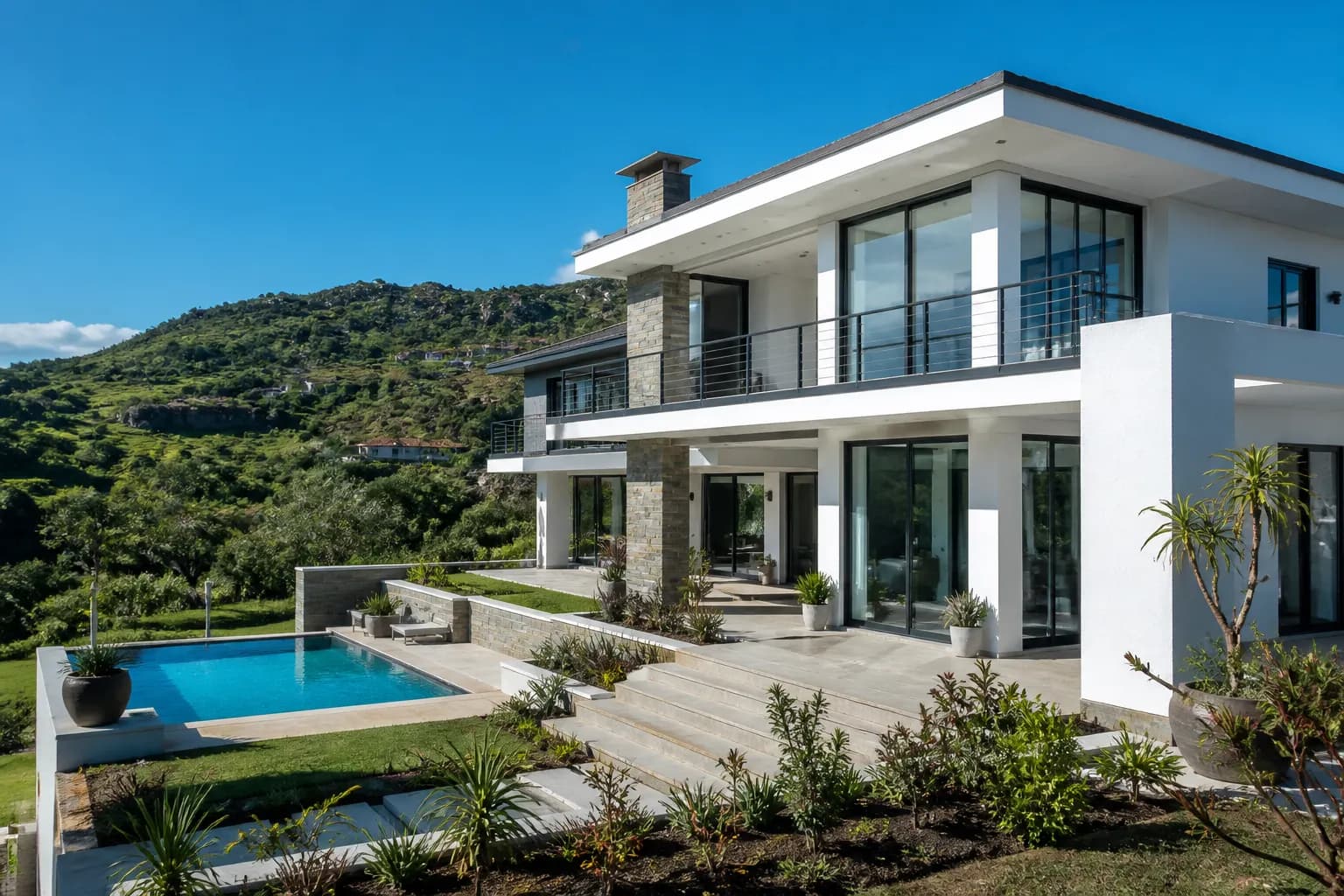 Luxury white two-storey home in the Eswatini hills on a bright sunny day